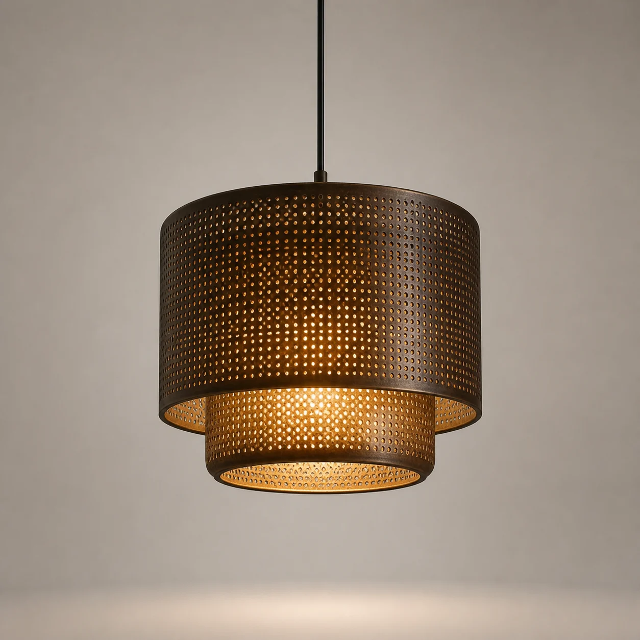 Mishkat Perforated Pendant studio concept visual in aged bronze, warm opal light