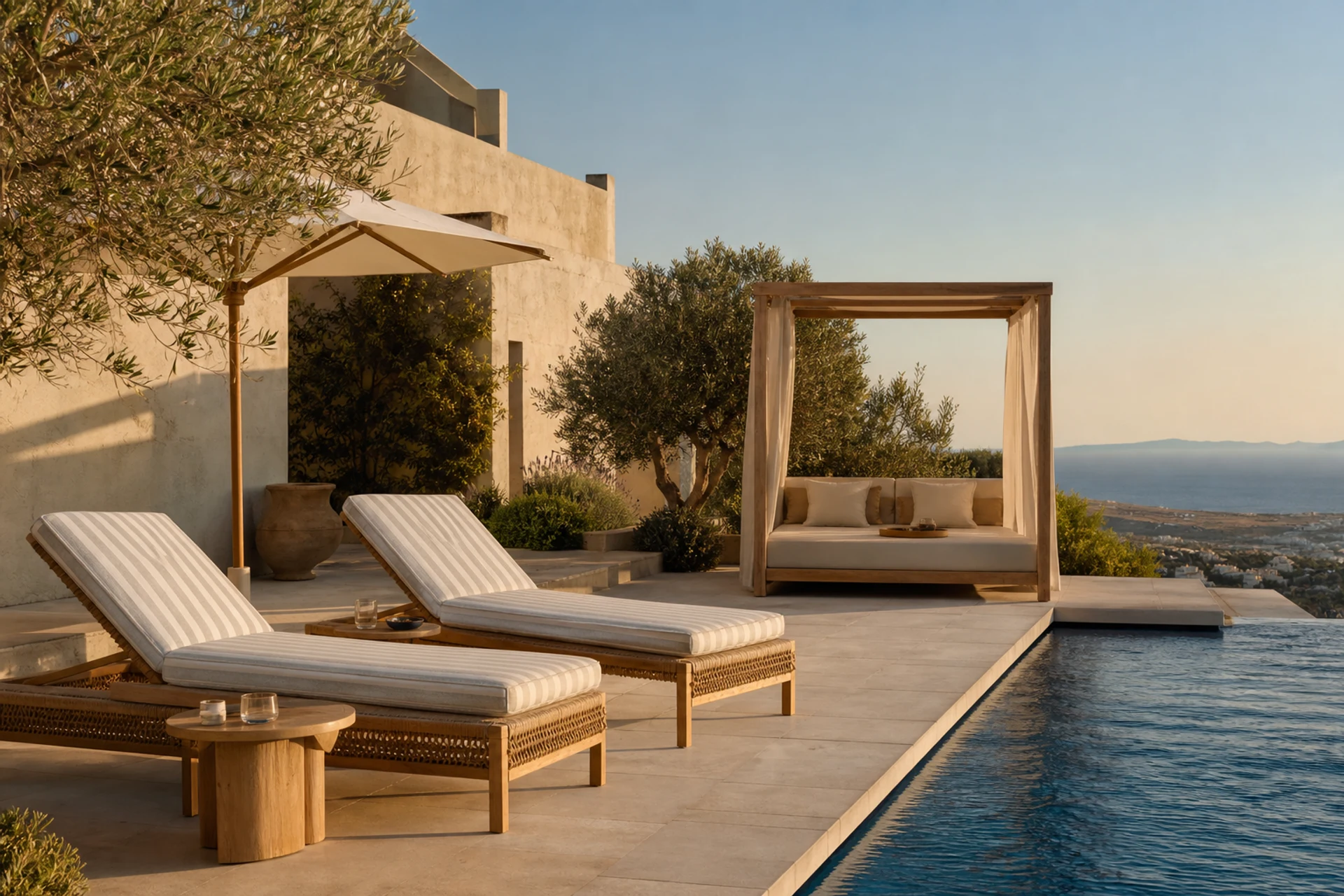 Mediterranean hotel pool terrace with teak rope chaise lounges, cabana daybed, side table, olive trees, and limestone decking