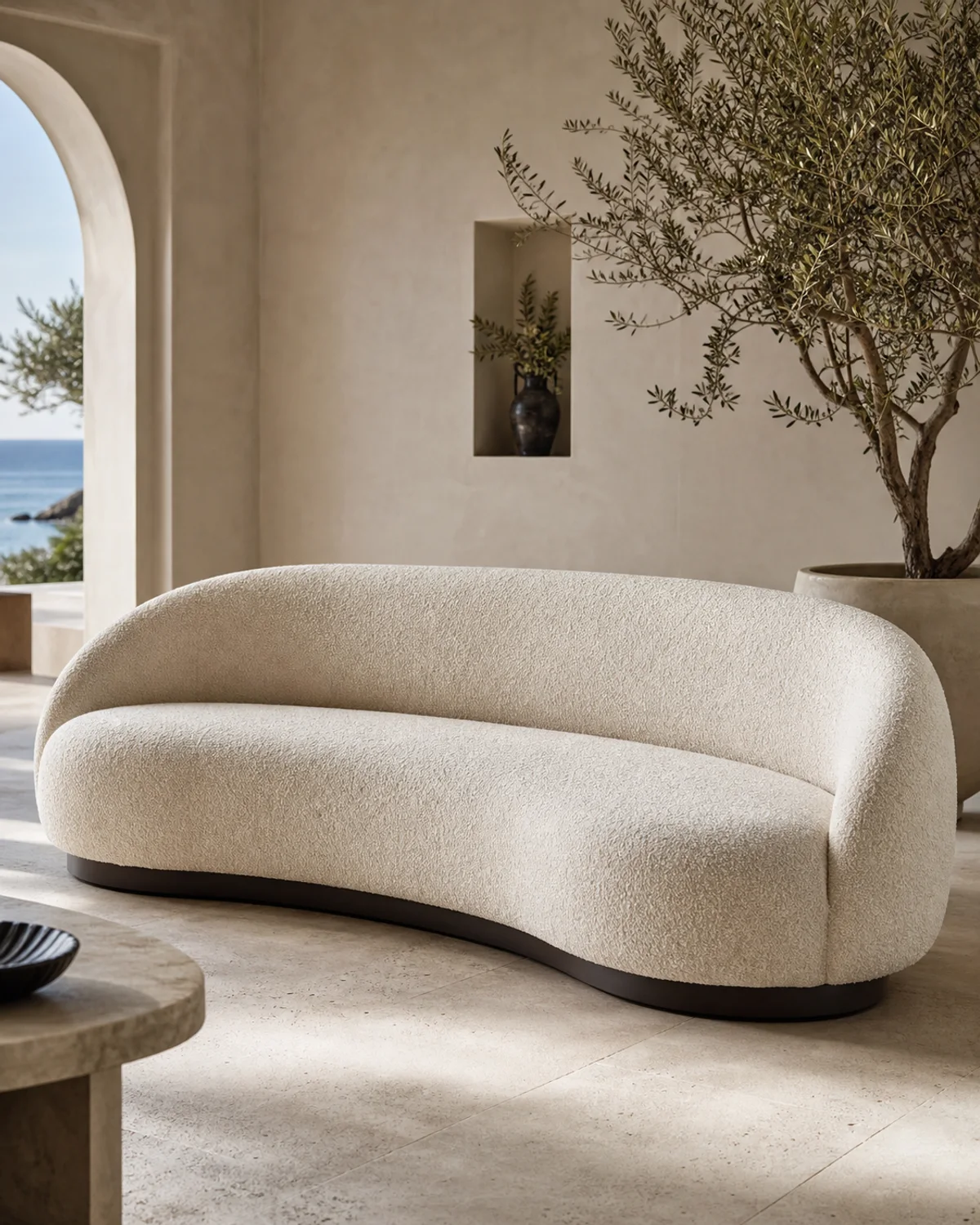 Curved ivory boucle lobby sofa with sculptural silhouette in a luxury hotel lounge — Mediterranean hotel lookbook