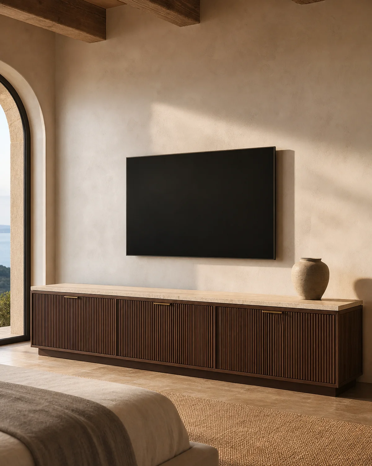 Fluted walnut media console with stone top in a refined hotel suite — Mediterranean hotel lookbook