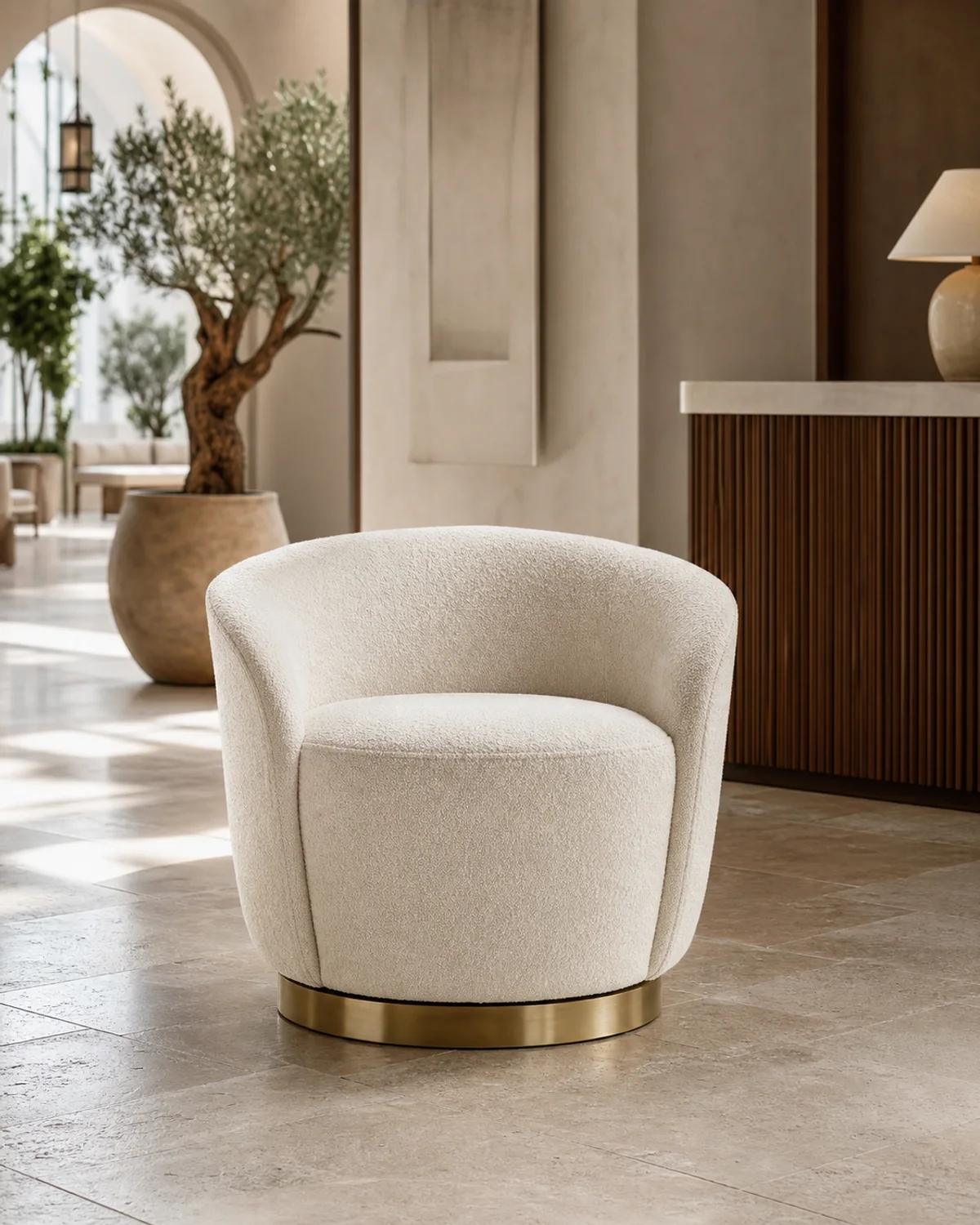 Ivory boucle luxury hotel lobby swivel chair with brushed brass circular base — Mediterranean hotel lookbook