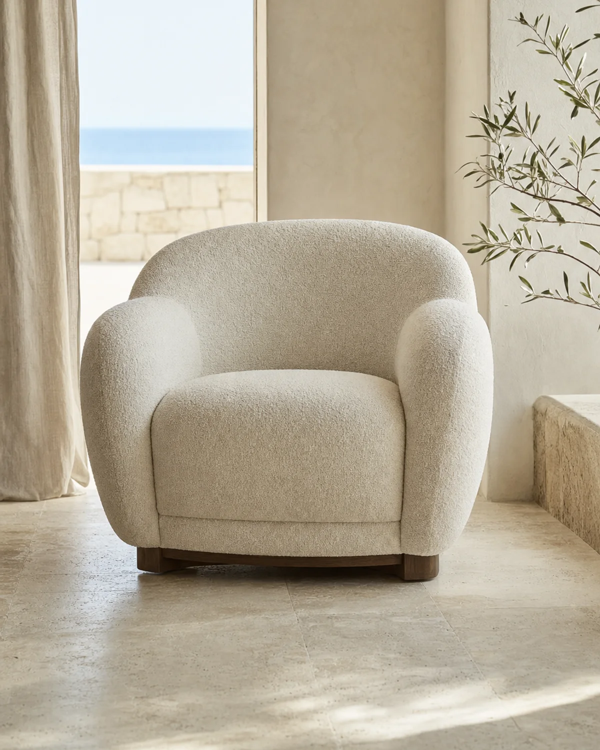 Sculptural upholstered lounge armchair in a refined hotel lobby setting — Mediterranean hotel lookbook