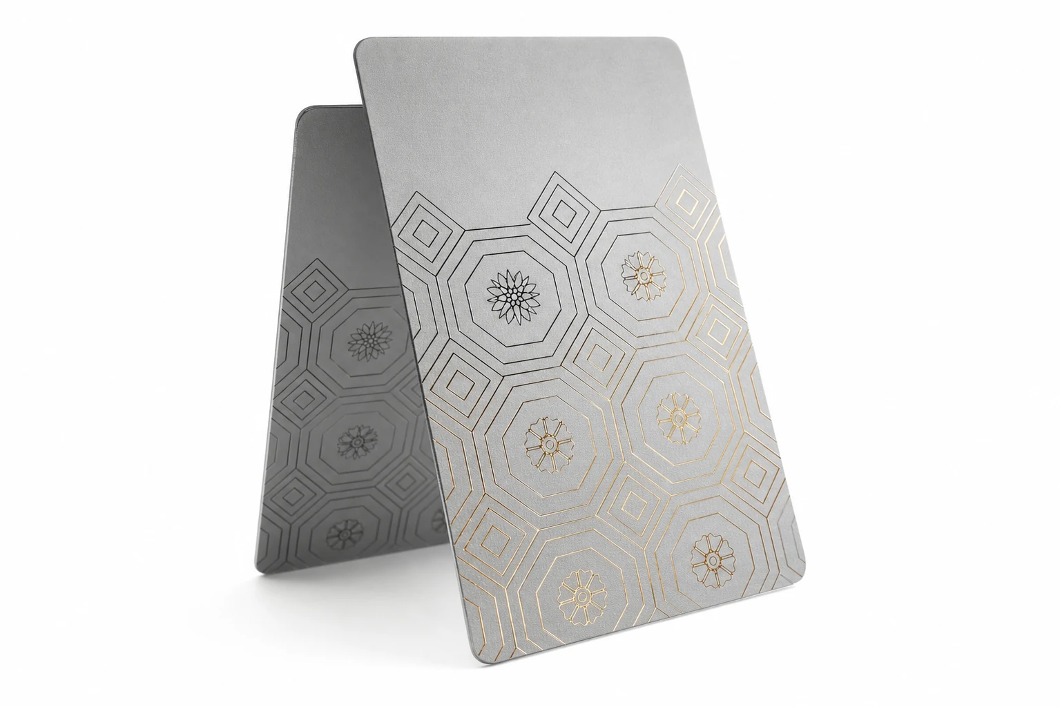 Hotel key cards with silver foil detailing fanned out on a dark surface